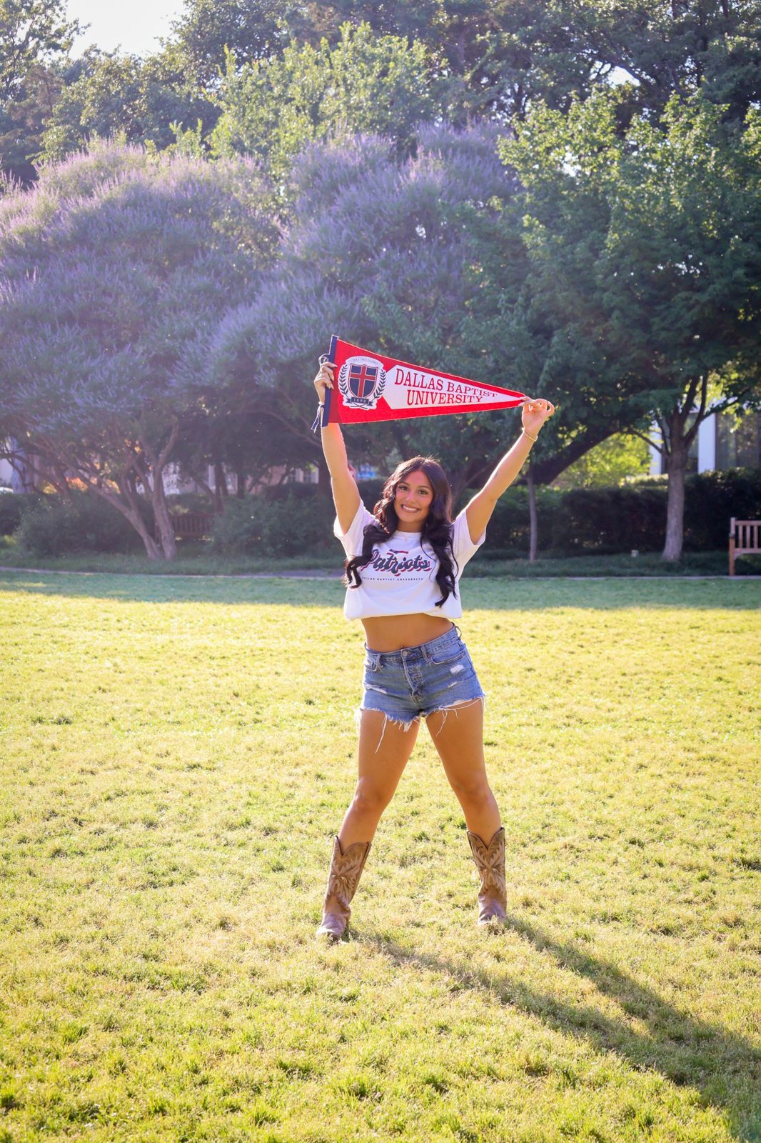 Senior portrait with Dallas Baptist pennant
