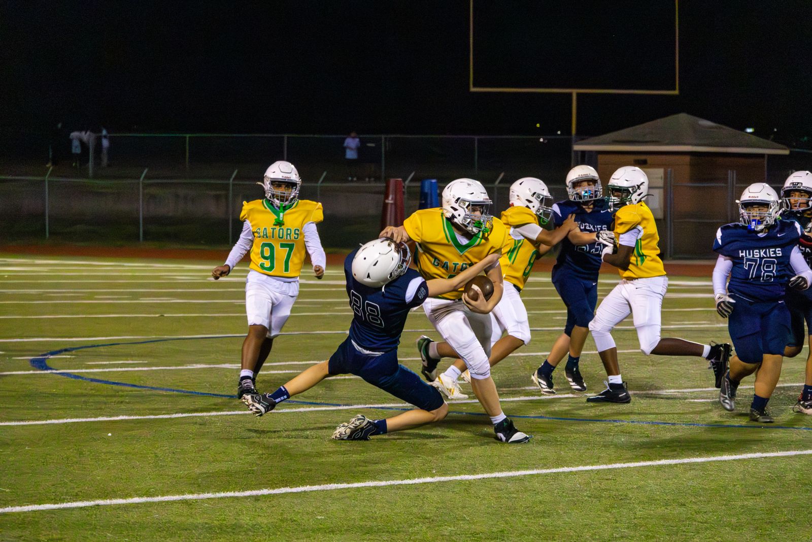 Youth football tackle at night